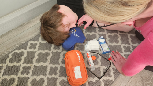 Person adminstering Buccal Midazolam to another person during a seizure