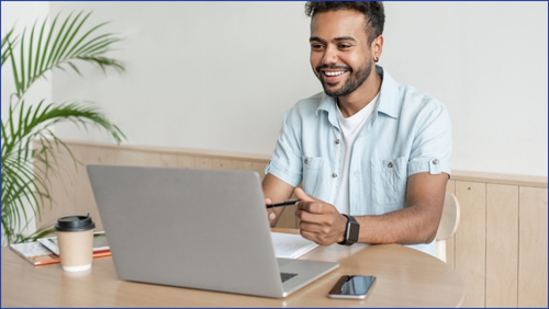 Young person looking at a laptop screen