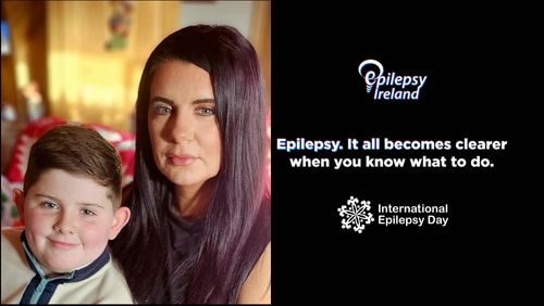 Luke and Michelle to the LHS of the picture with EI Logo and message: Epilepsy, it all becomes clearer when you know what to do on a black background with International Epilepsy Day logo at bottom