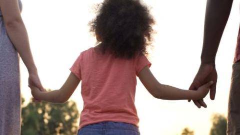 Child holding parent's hand