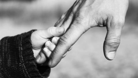 Child holding parent's hand