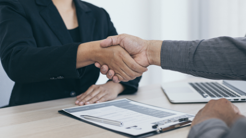 People shaking hands at job interview. 